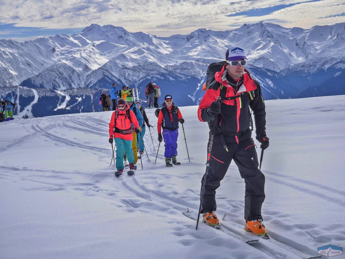 3 a group of people standing on top of a snow covered mountain