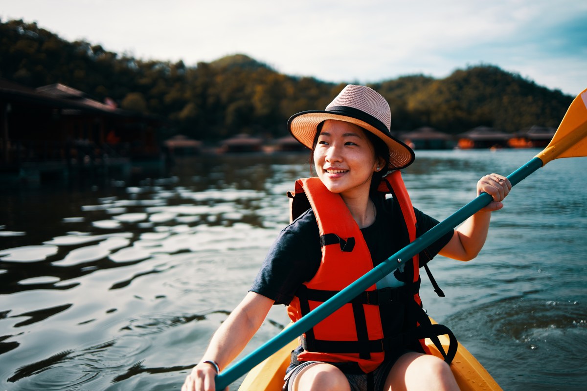 Asian girl is kayaking at Kanchanaburi, Thailand. Asian girl is kayaking at Kanchanaburi, Thailand.