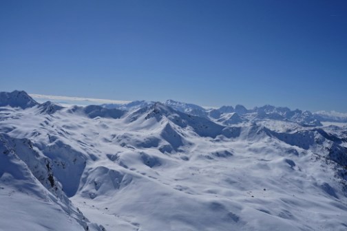 Snow-covered mountain range under a clear blue sky