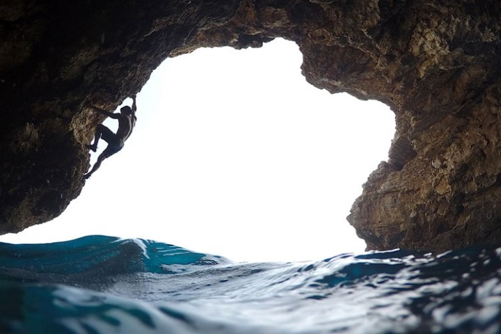 a man riding on the back of a cave