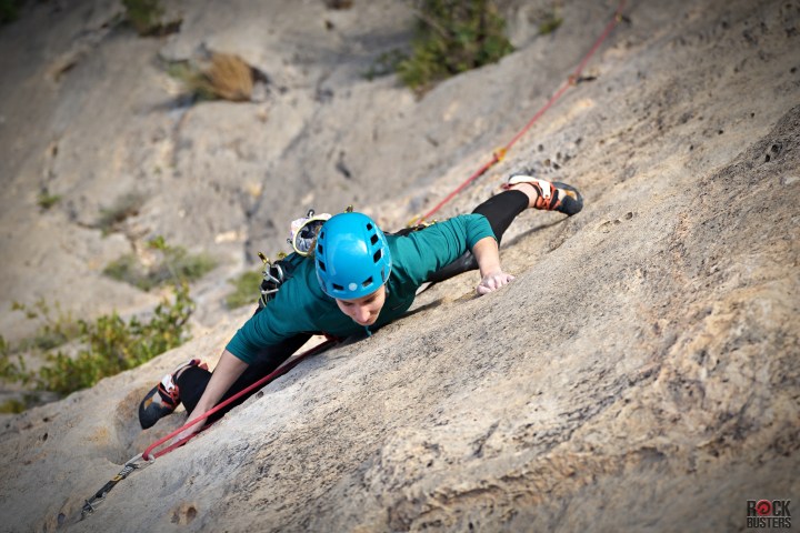 a boy sitting on a rock