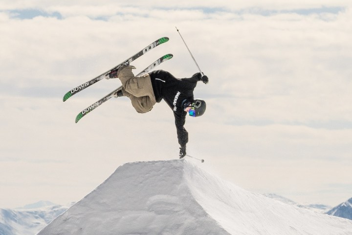 a man flying through the air while riding a snow board