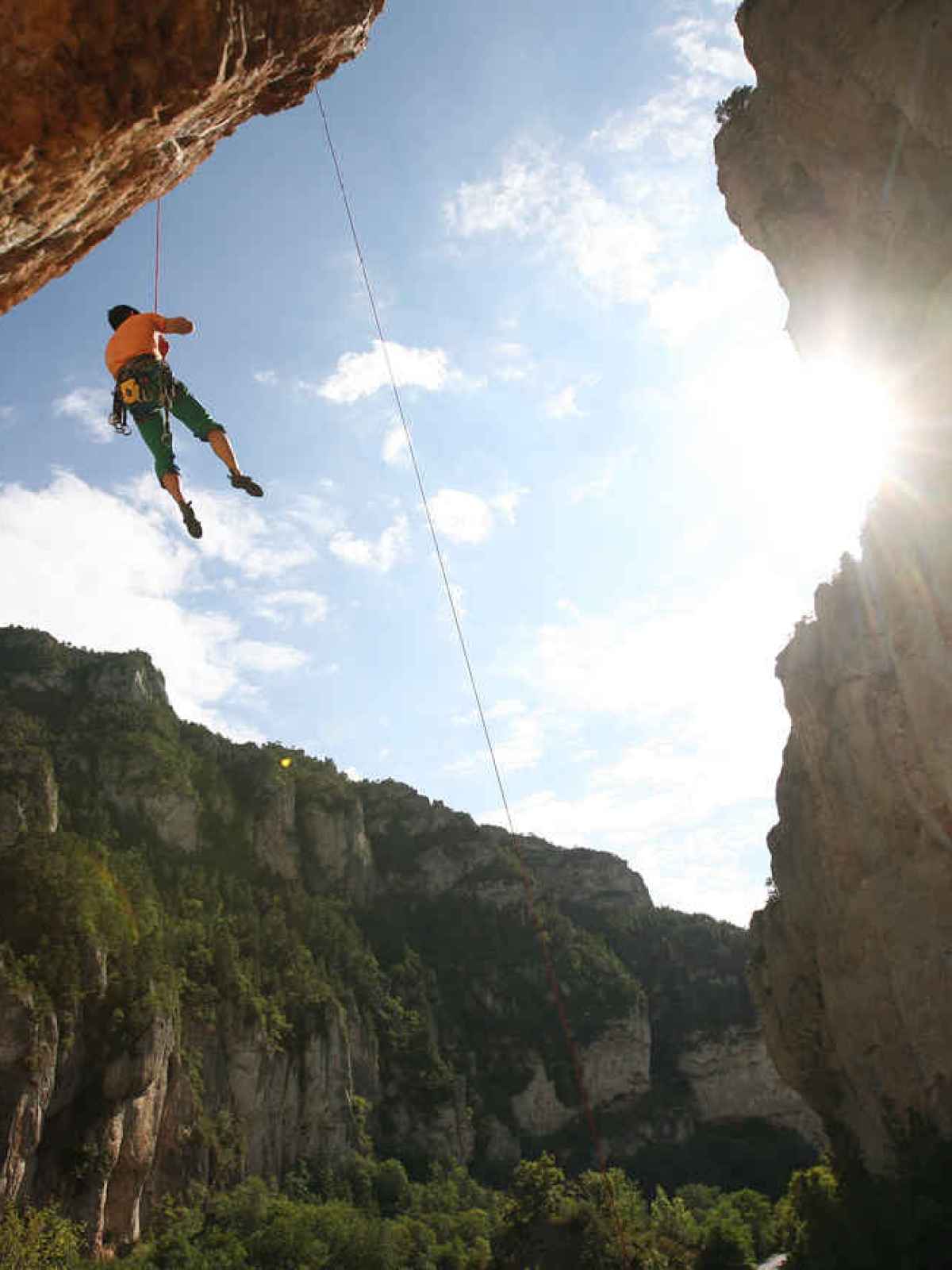 a man flying through the air on a rocky hill