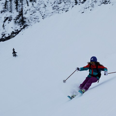 a man riding skis down a snow covered slope