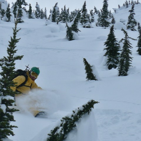 a man riding skis down a snow covered slope