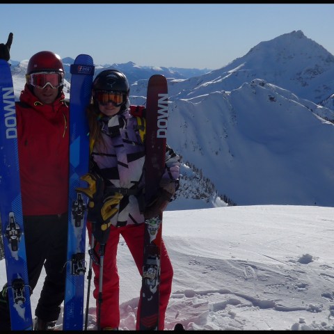 a group of people standing on top of a snow covered slope
