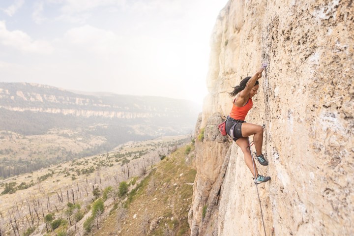 a man flying through the air on top of a mountain