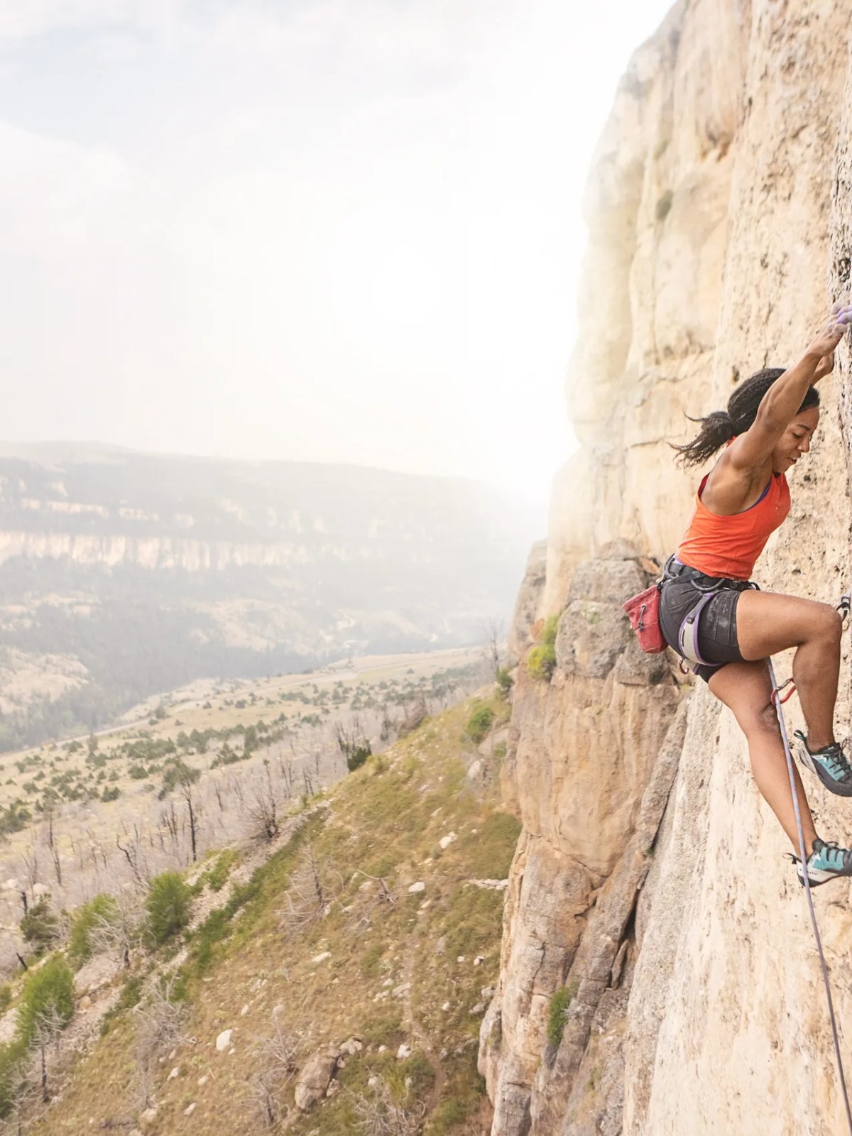 a man flying through the air on top of a mountain